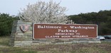a picture of the Baltimore Washington Parkway sign with flowers blooming